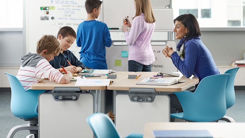 students and teacher on collaborative table 