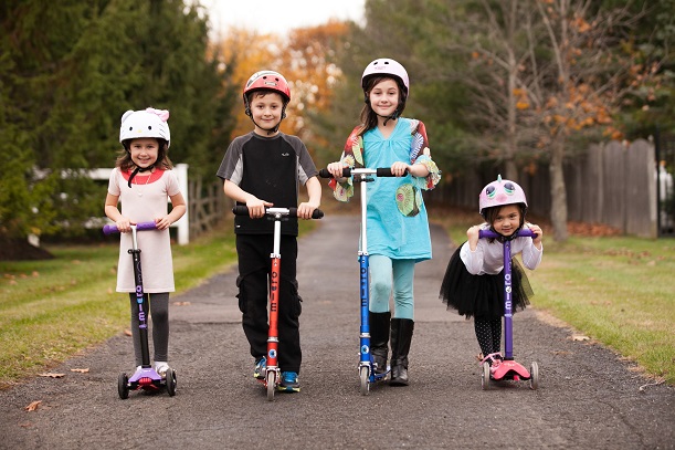 four kids on kick scooters
