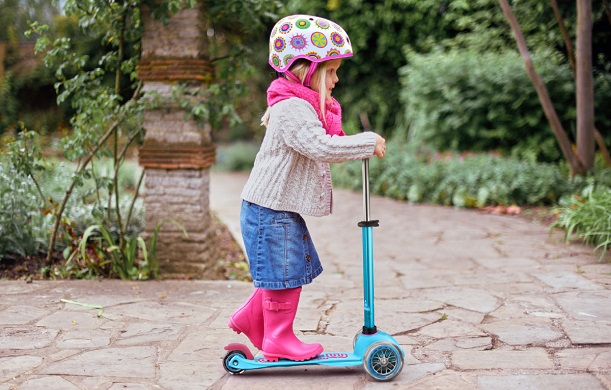 young girl riding scooter
