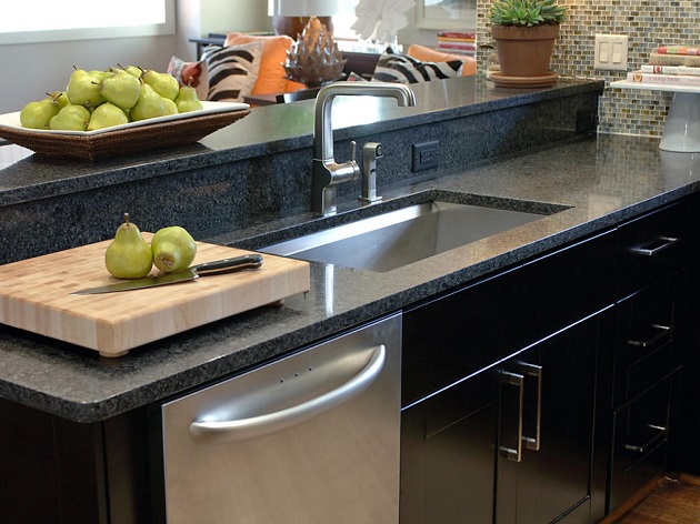black kitchen with stainless steel sink