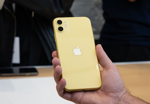 holding yellow iphone 11