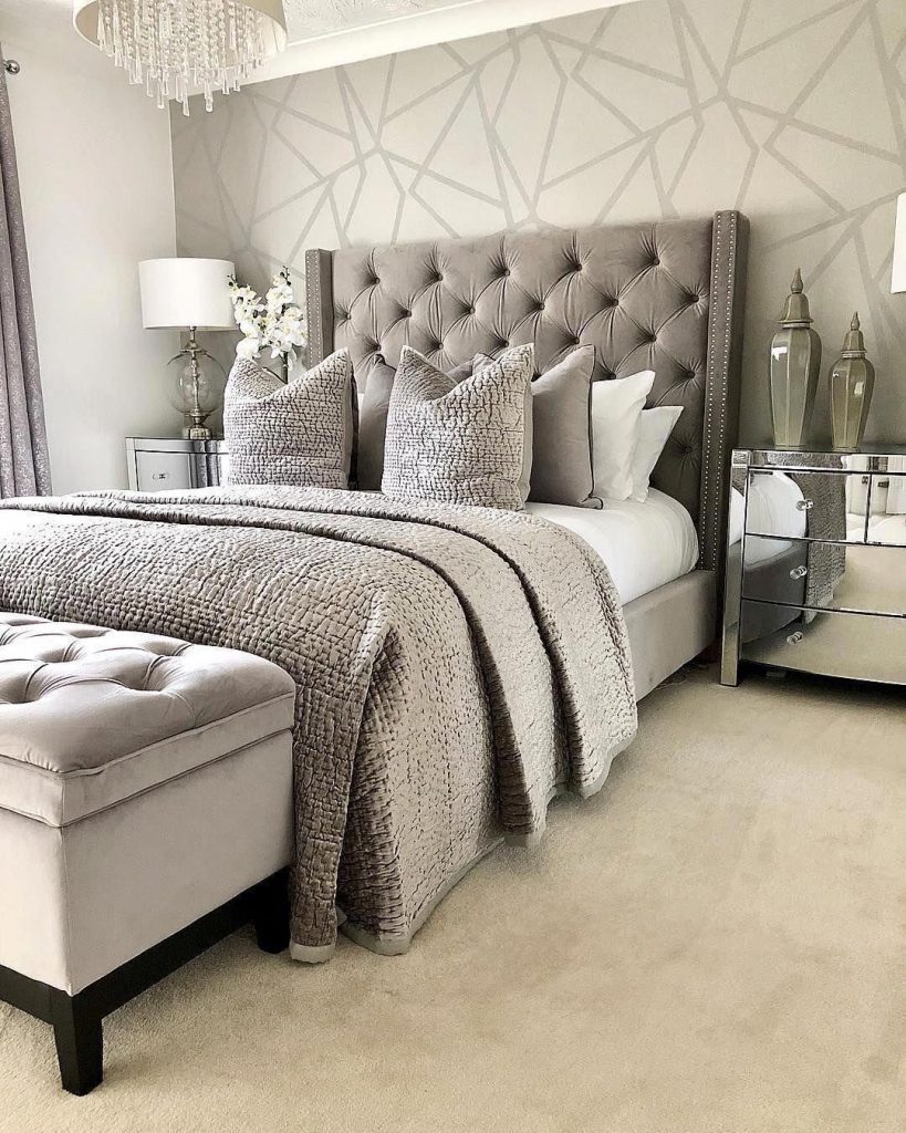 beautiful bedroom with gray bed and mirror bedside tables