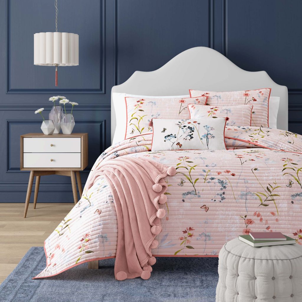 blue wall bedroom with floral bedding
