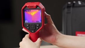 Man holding red thermal imaging camera