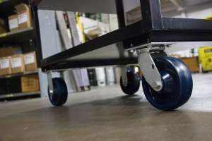 Close-up of a heavy-duty blue wheel caster on industrial shelving.